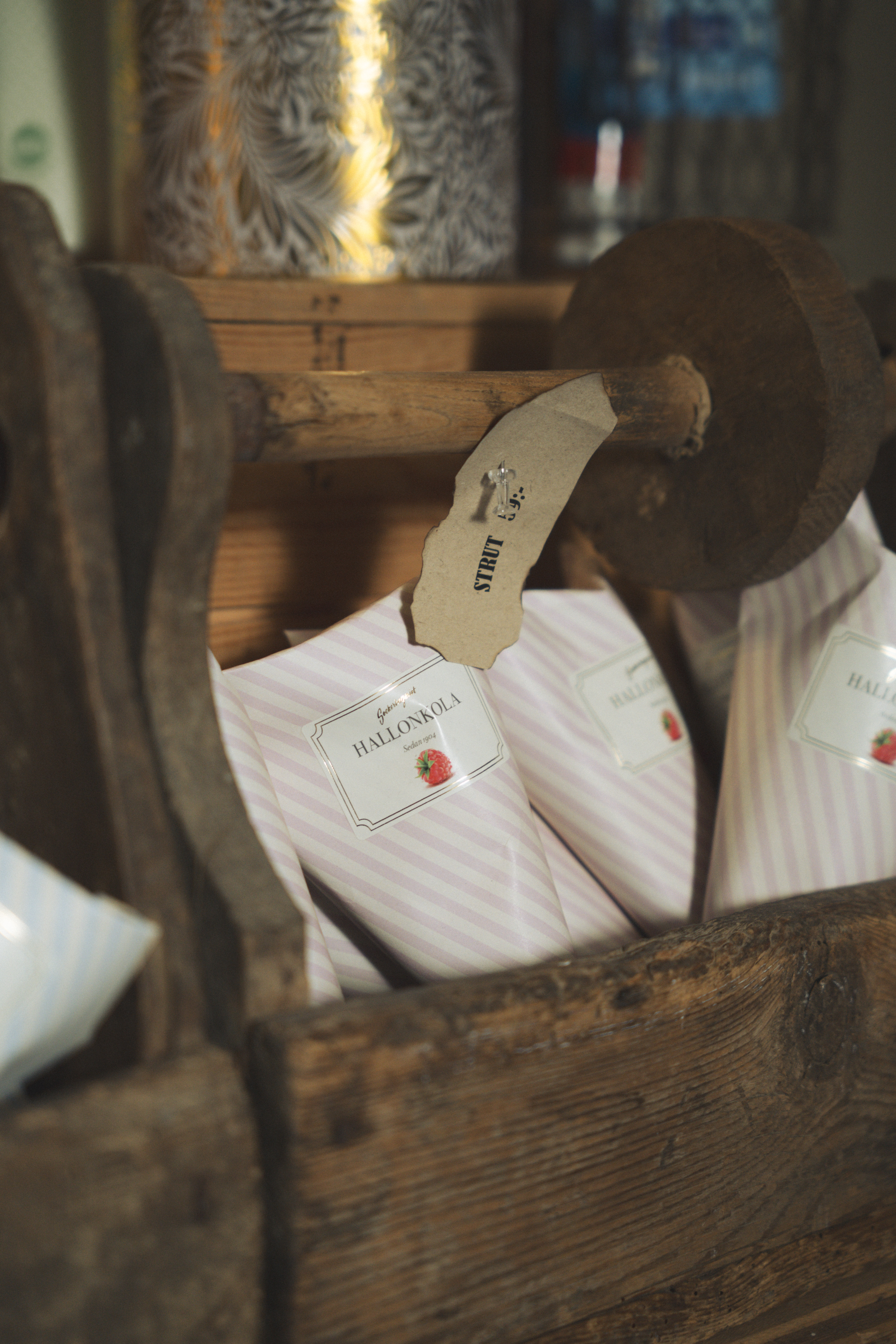 Bags of toffees in a wooden box at reception at Hotell Kungshaga